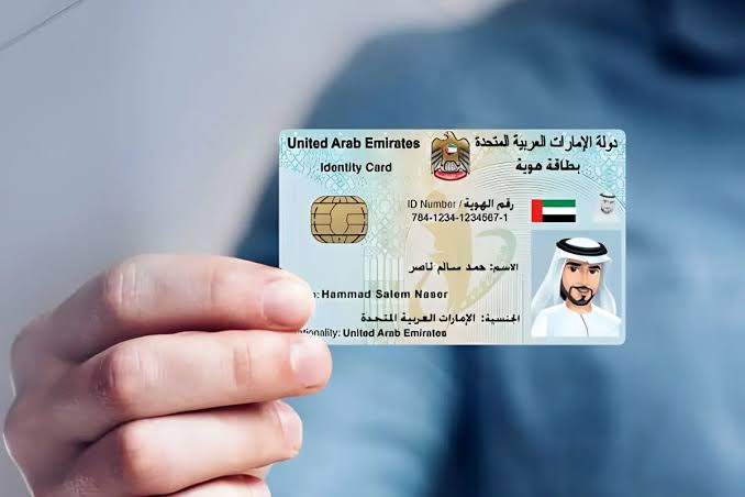 Illustration of a sample UAE identity card held in a hand