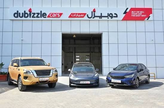 Used cars displayed outside a Dubai car dealership