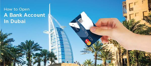 Bank card held in front of the Burj Al Arab in Dubai